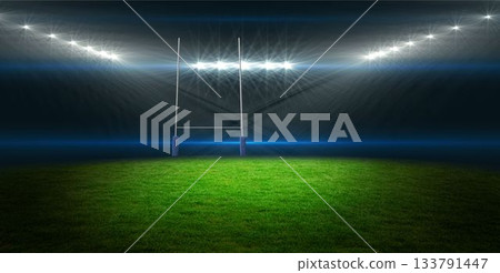 Flat design rugby goalposts with padded bases are standing on grassy pitch under bright floodlights 133791447