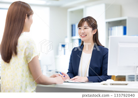 Business woman serving customers at the counter Business woman serving customers at the counter 133792040