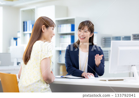 Business woman serving customers at the counter Business woman serving customers at the counter 133792041