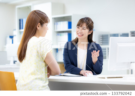 Business woman serving customers at the counter Business woman serving customers at the counter 133792042