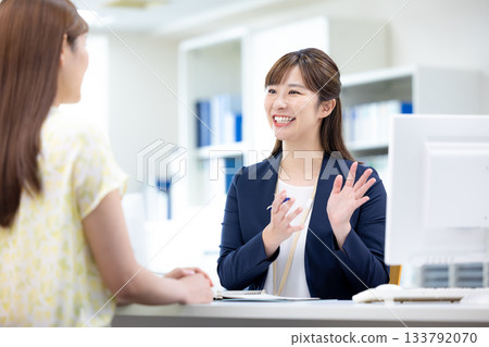 Business woman serving customers at the counter Business woman serving customers at the counter 133792070