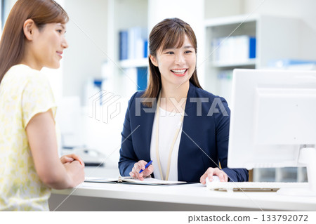 Business woman serving customers at the counter 133792072