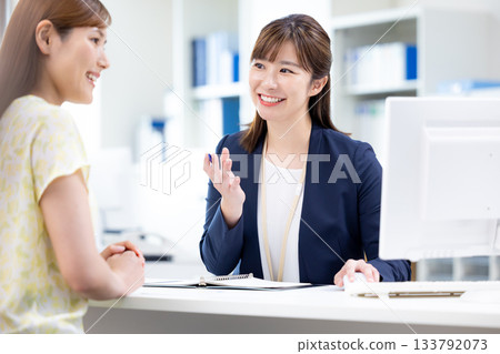 Business woman serving customers at the counter 133792073