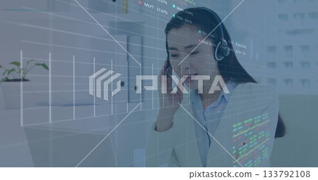 Working business professional analyzing stock charts, code on laptop at office with headset Working business professional analyzing stock charts, code on laptop at office with headset 133792108