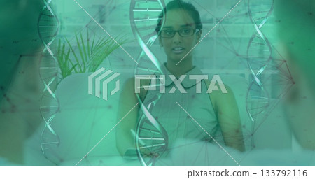 Asian woman in sleeveless blouse leading biotech discussion in office lounge, with DNA graphics Asian woman in sleeveless blouse leading biotech discussion in office lounge, with DNA graphics 133792116