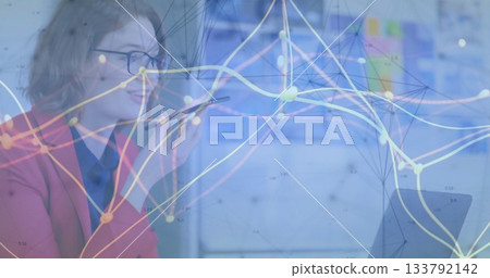 Talking red blazer manager holding smartphone glancing laptop in office with data, copy space Talking red blazer manager holding smartphone glancing laptop in office with data, copy space 133792142