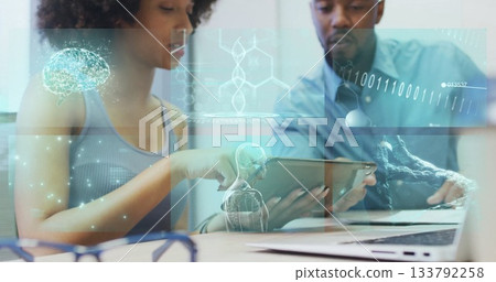 Two researchers collaborating, examining medical holograms on tablet at lab, laptop and eyeglasses Two researchers collaborating, examining medical holograms on tablet at lab, laptop and eyeglasses 133792258