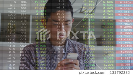 Checking Asian man monitoring stock market data on smartphone at office lounge, with ticker overlay Checking Asian man monitoring stock market data on smartphone at office lounge, with ticker overlay 133792283