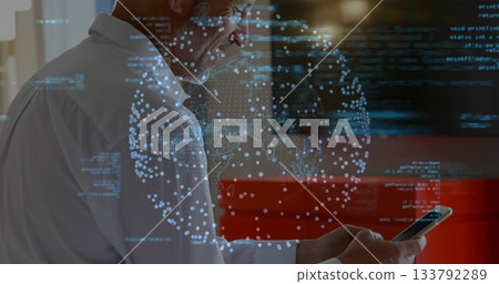 Man in white shirt holding smartphone and viewing holographic globe with code in office, copy space 133792289