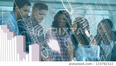 Analyzing data, six professionals leaning over holographic charts in meeting room with tablet 133792322