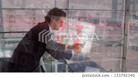 Leaning man in suit using phone near metal railing at airport terminal, with data projections Leaning man in suit using phone near metal railing at airport terminal, with data projections 133792340