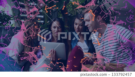 Young adults gathered around tablet with digital network image overlay 133792457