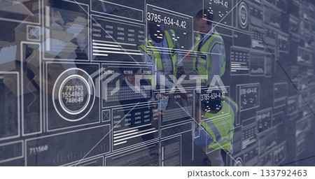 Analyzing digital data interfaces and graphs, engineers in safety vests working 133792463