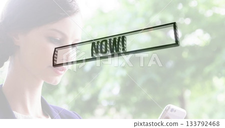 Checking smartphone female professional wearing navy blazer in garden with NOW overlay, copy space Checking smartphone female professional wearing navy blazer in garden with NOW overlay, copy space 133792468