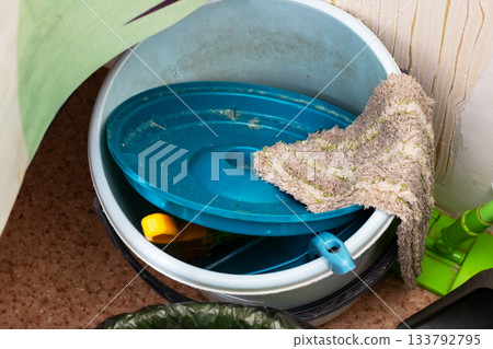 Daily chores in humble setting, Realistic depiction of daily household cleaning duties and tools 133792795