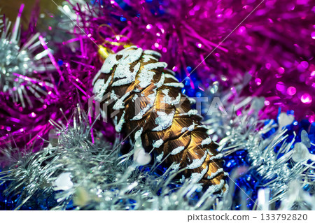 Winter festive decoration, Seasonal home decor featuring frosted pine with shimmering tinsel 133792820