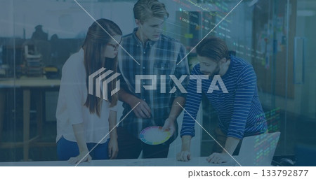 Three colleagues leaning and examining layout in meeting room, with color wheel and printed sheets Three colleagues leaning and examining layout in meeting room, with color wheel and printed sheets 133792877