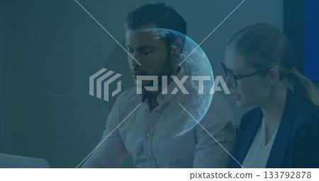 Colleagues in business attire analyzing data on laptop in office, with holographic planet overlay Colleagues in business attire analyzing data on laptop in office, with holographic planet overlay 133792878