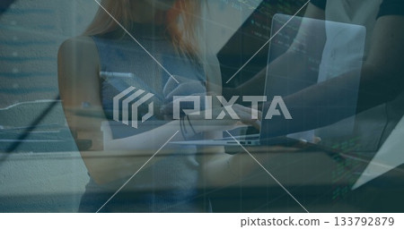 Female and male developers typing code on laptop at table in office workspace, with coding overlay Female and male developers typing code on laptop at table in office workspace, with coding overlay 133792879