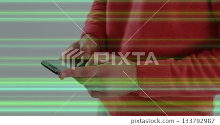 Using smartphone, person interacting with digital green image in school setting Using smartphone, person interacting with digital green image in school setting 133792987