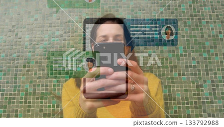 Using smartphone, person receiving social media notifications with image overlay Using smartphone, person receiving social media notifications with image overlay 133792988