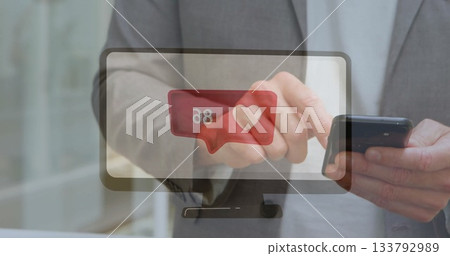 Tapping smartphone, man in gray suit in office corridor, with red heart alert on monitor graphic Tapping smartphone, man in gray suit in office corridor, with red heart alert on monitor graphic 133792989