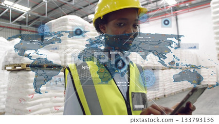 Inspecting woman in safety gear holding tablet and viewing overlays in warehouse, with white sacks Inspecting woman in safety gear holding tablet and viewing overlays in warehouse, with white sacks 133793136