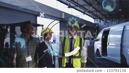 Team in hard hats and vest touring loading bay inside warehouse, with forklift and pallets Team in hard hats and vest touring loading bay inside warehouse, with forklift and pallets 133793138