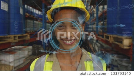 standing warehouse worker wearing hard hat and safety vest in warehouse aisle, with HUD overlay standing warehouse worker wearing hard hat and safety vest in warehouse aisle, with HUD overlay 133793140