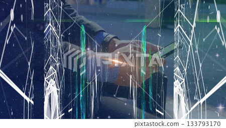 Viewing data overlay on smartphone, man in suit, wristwatch sitting on lounge bench, with suitcase 133793170