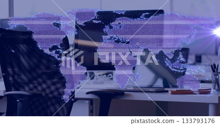 Displaying digital world map overlay across office, with flatscreen monitor, laptop, notebook 133793176