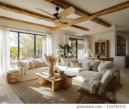 Cozy boho living room with large wooden beams, neutral sofa, textured rug, natural light and pampas grass 133793335