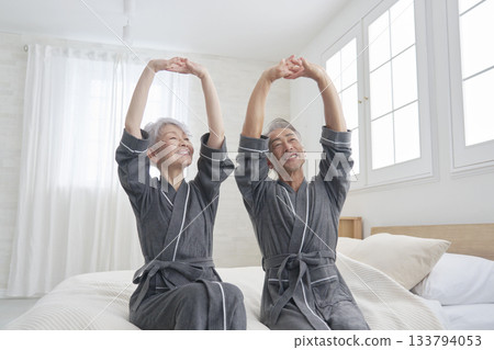Senior couple stretching in the bedroom 133794053