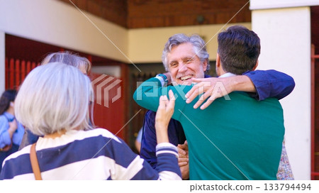 Senior friends greeting and hugging each other outdoors 133794494