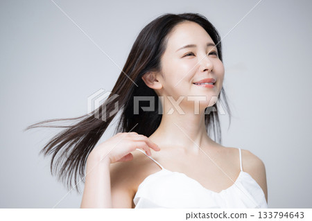 Portrait of a woman with long black hair blowing in the wind. Image of beauty, hair care, treatment, etc. 133794643