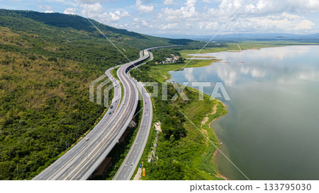 Drone shot The M6 motorway Nakhon Ratchasima Province - Bang Pa-in Lam Ta Khong River and Mountain. Motorway Korat Thailand Drone shot The M6 motorway Nakhon Ratchasima Province - Bang Pa-in Lam Ta Khong River and Mountain. Motorway Korat Thailand 133795030