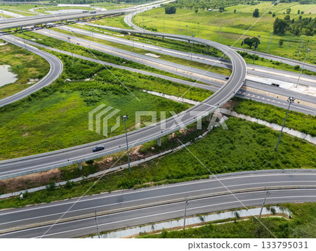 Drone shot a large highway interchange crossing over green farmlands in Thailand Drone shot a large highway interchange crossing over green farmlands in Thailand 133795031