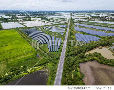 Aerial view drone shot scenic landscape of a road passing through a solar farm in Thailand 133795034