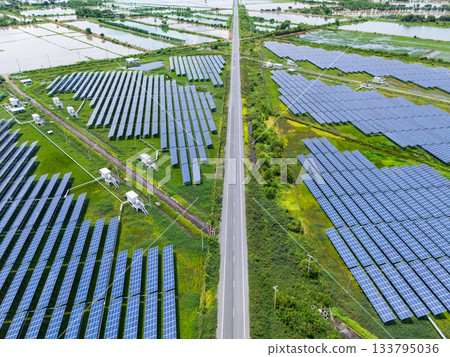 Aerial view drone shot scenic landscape of a road passing through a solar farm in Thailand 133795036