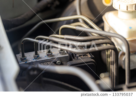 ABS Anti lock braking system. close up of an automotive braking module, intricate mechanical parts that represent advanced vehicle safety design 133795037