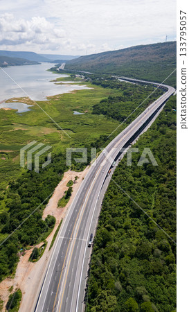 Drone shot The M6 motorway Nakhon Ratchasima Province - Bang Pa-in Lam Ta Khong River and Mountain. Motorway Korat Thailand Drone shot The M6 motorway Nakhon Ratchasima Province - Bang Pa-in Lam Ta Khong River and Mountain. Motorway Korat Thailand 133795057