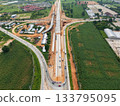 Drone shot of highway and overpass construction site with vehicles and road in a rural place 133795095