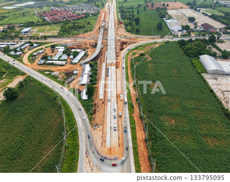 Drone shot of highway and overpass construction site with vehicles and road in a rural place 133795095