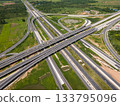 Drone shot a large highway interchange crossing over green farmlands in Thailand 133795096