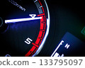 Close-up of a diesel truck's dashboard and tachometer. It represents the power and durability of a work vehicle, with a clear focus on the round engine meters. 133795097