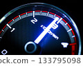 Close-up of a diesel truck's dashboard and tachometer. It represents the power and durability of a work vehicle, with a clear focus on the round engine meters. 133795098