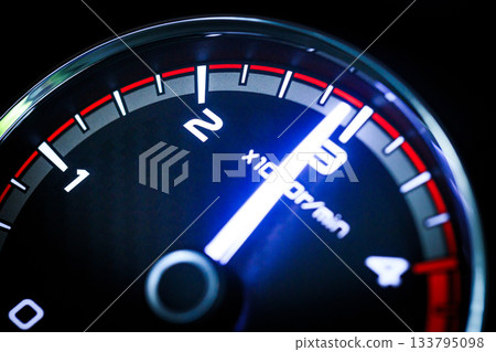 Close-up of a diesel truck's dashboard and tachometer. It represents the power and durability of a work vehicle, with a clear focus on the round engine meters. 133795098