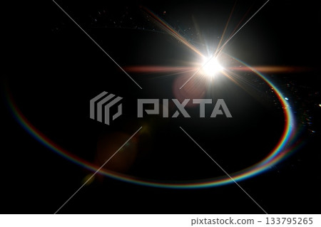 Abstract solar eclipse with lens flare and rainbow light 133795265