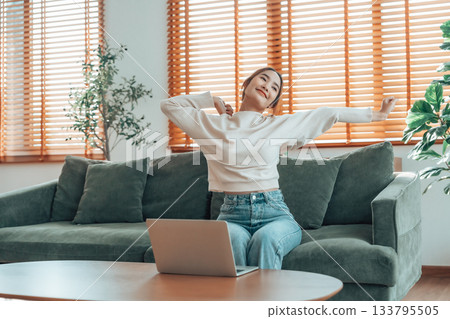 Young asian woman feeling pain in neck and shoulder after working on computer laptop for a long time 133795505