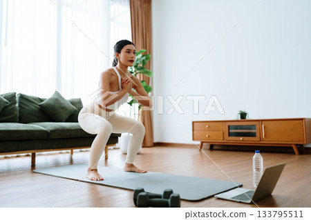 Young Asian beautiful woman doing aerobic exercise at home Young Asian beautiful woman doing aerobic exercise at home 133795511
